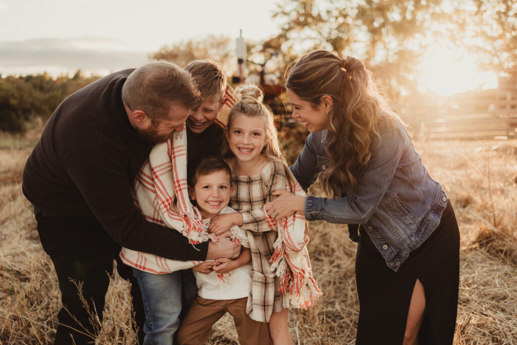 family enjoying each other during golden hour sunlight